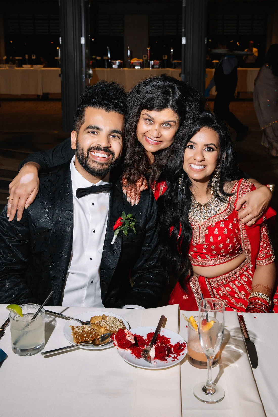 Mudita embracing a smiling couple during their celebration