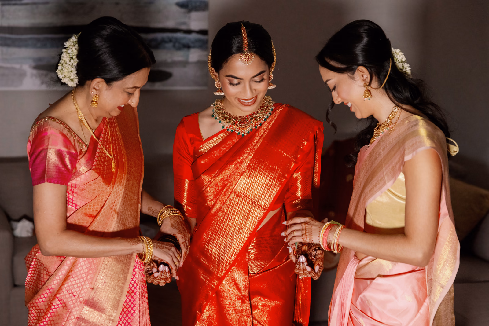 Loved ones carefully helping the bride prepare