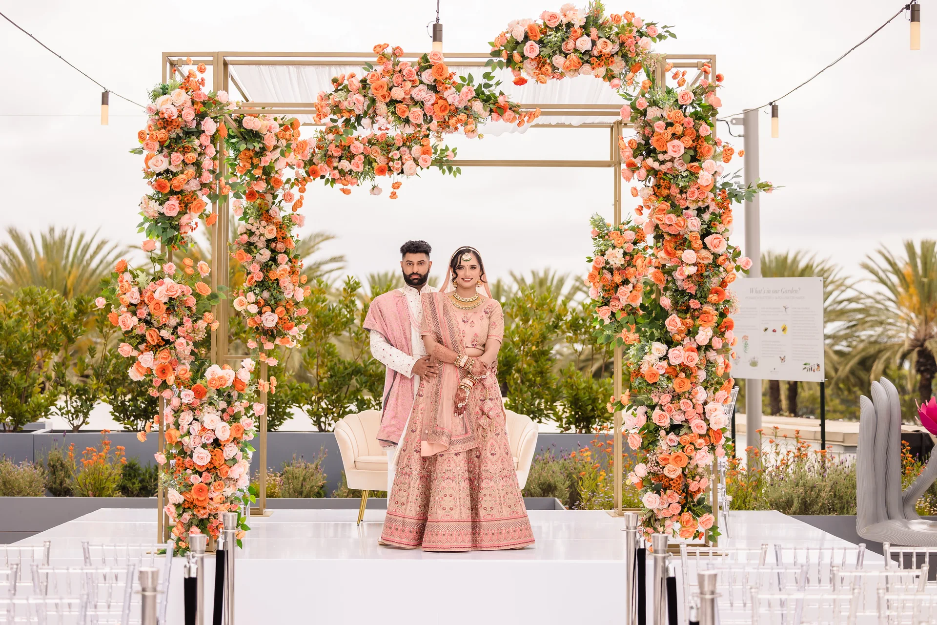 Arpita & Varad beneath their floral mandap