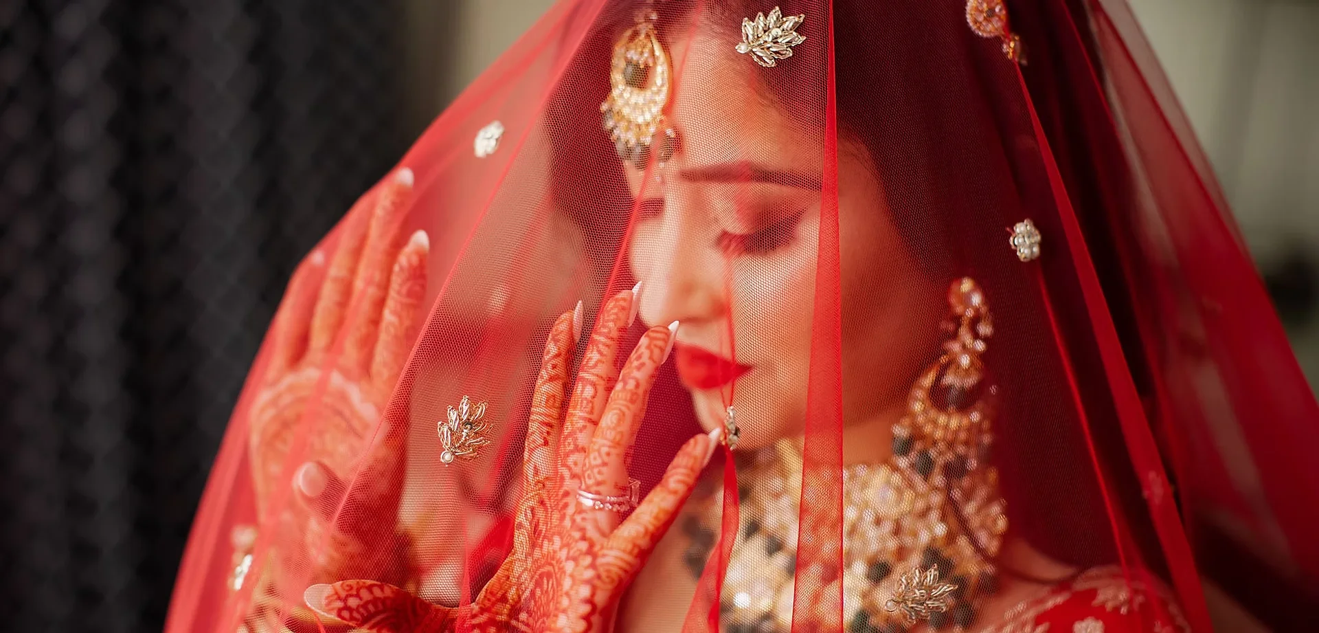 Ayesha beneath her red bridal veil