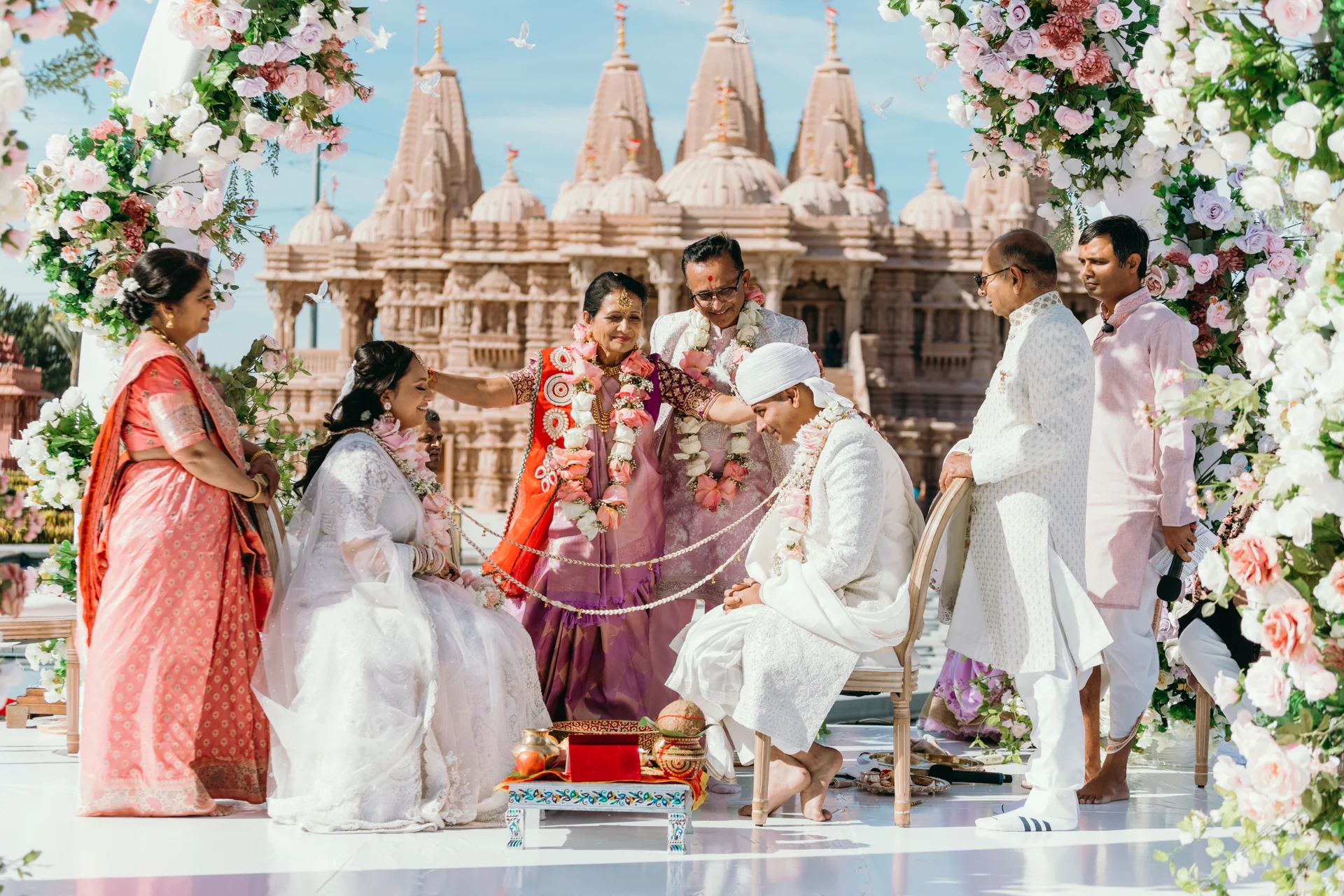 Purna and Mayur with family during their temple wedding ceremony.