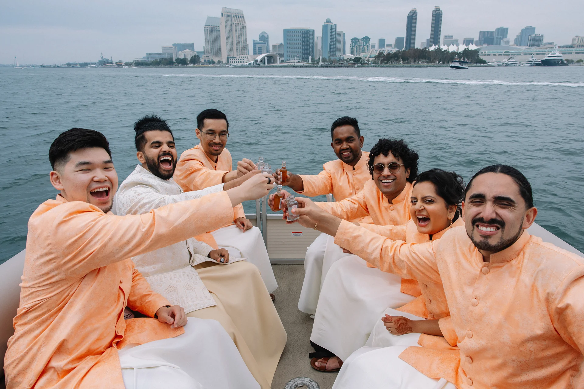 Friends celebrating together beside the water at Rafa and Naveen’s wedding.