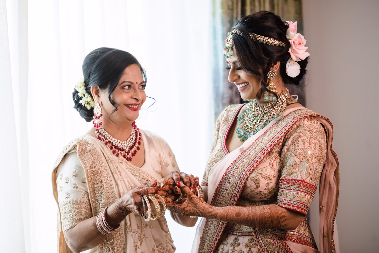 Natasha sharing a warm moment while receiving help with her bridal preparation