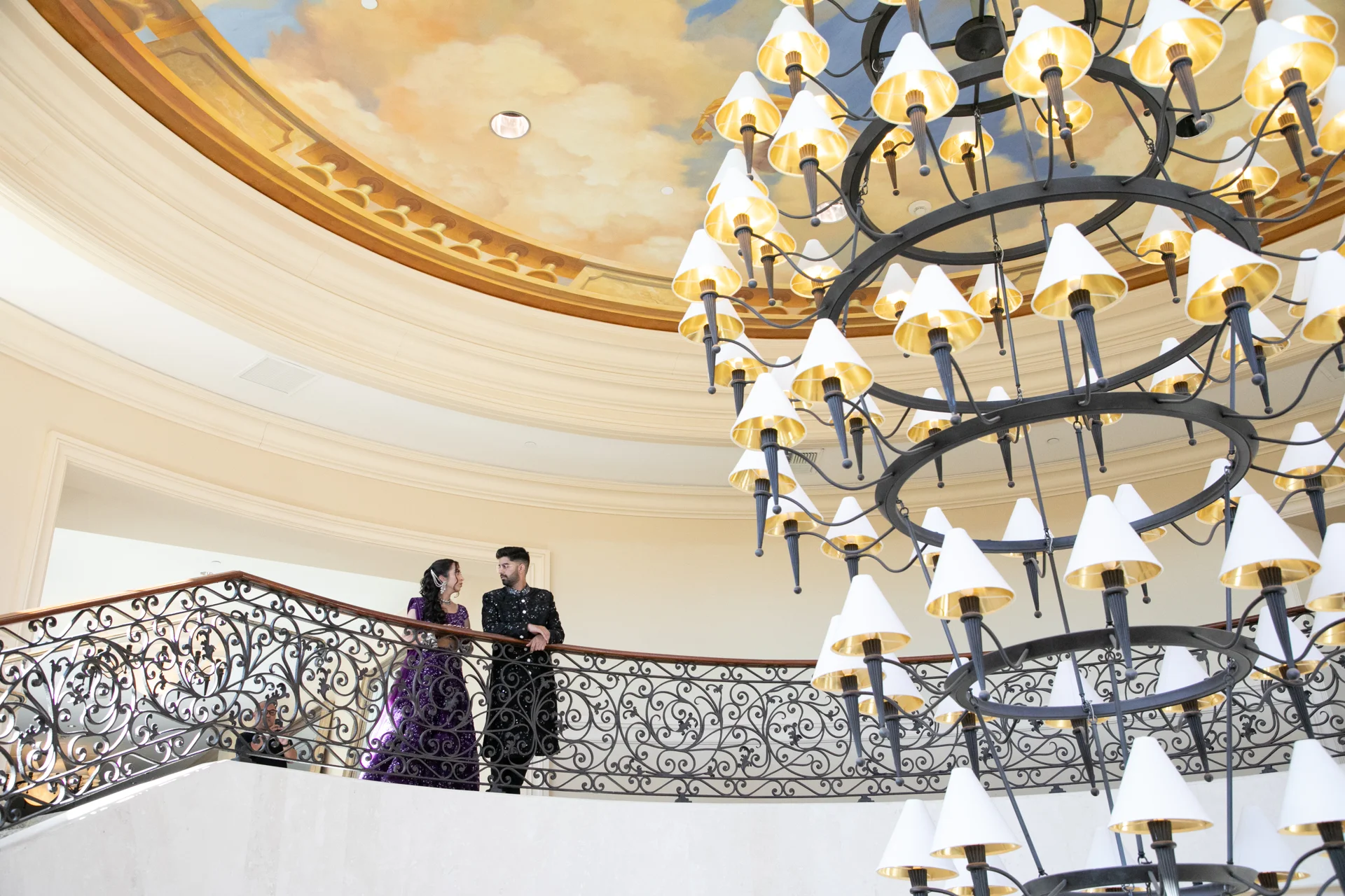 Avani & Abhi — together beneath the chandelier