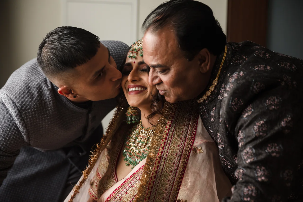 Natasha sharing an affectionate moment with her parents.