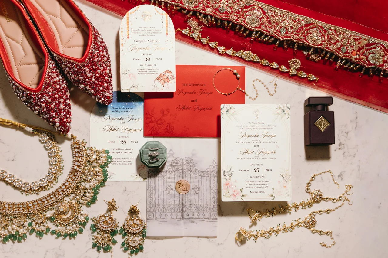 Priyanka’s bridal clothing, jewelry and invitation arranged before getting ready.