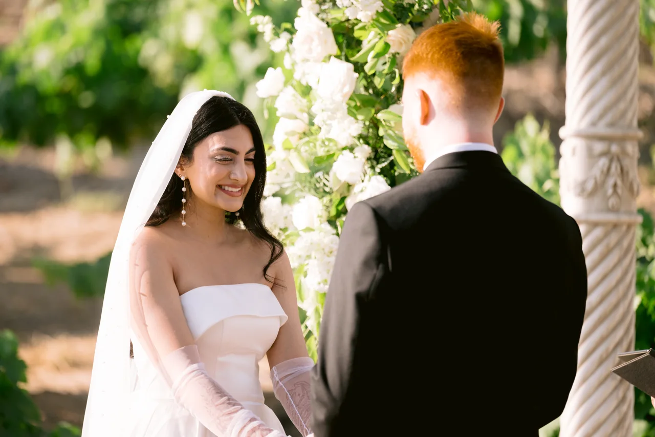 Reena and Zach sharing a moment during their American wedding ceremony.