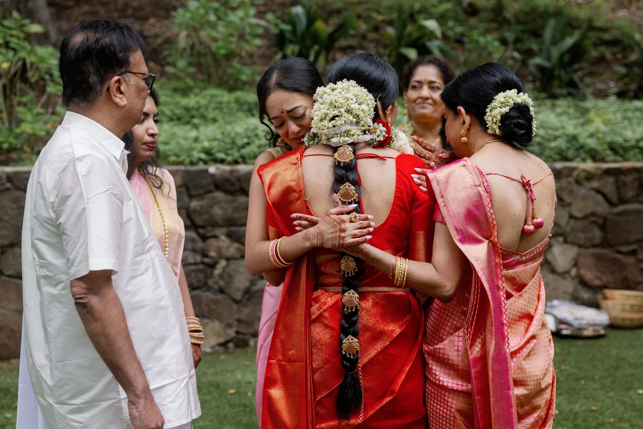 Sandhiya sharing an emotional embrace with loved ones.