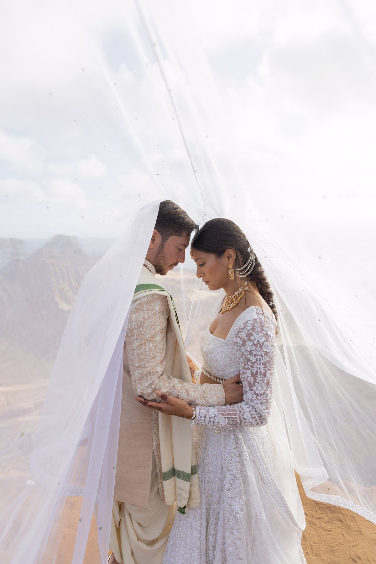 Brisa & Shakti sharing a quiet moment beneath her lace veil