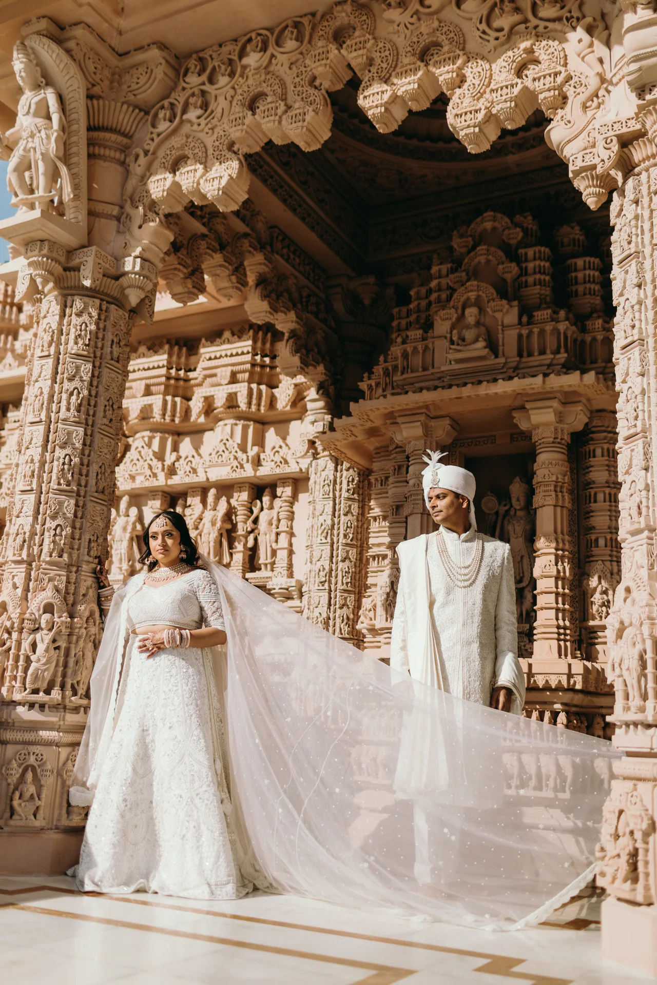 Purna and Mayur together within the carved temple architecture