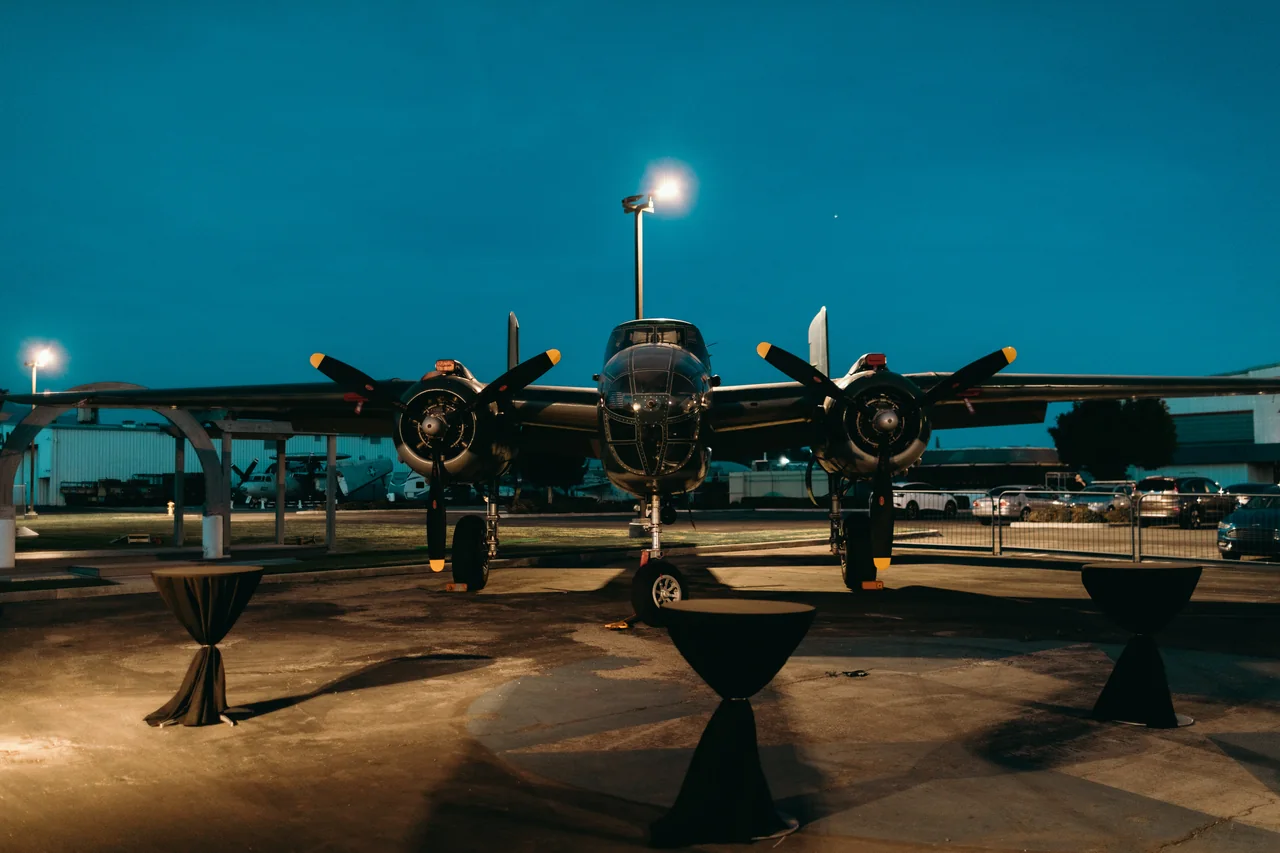 The reception setting beneath an illuminated aircraft at dusk